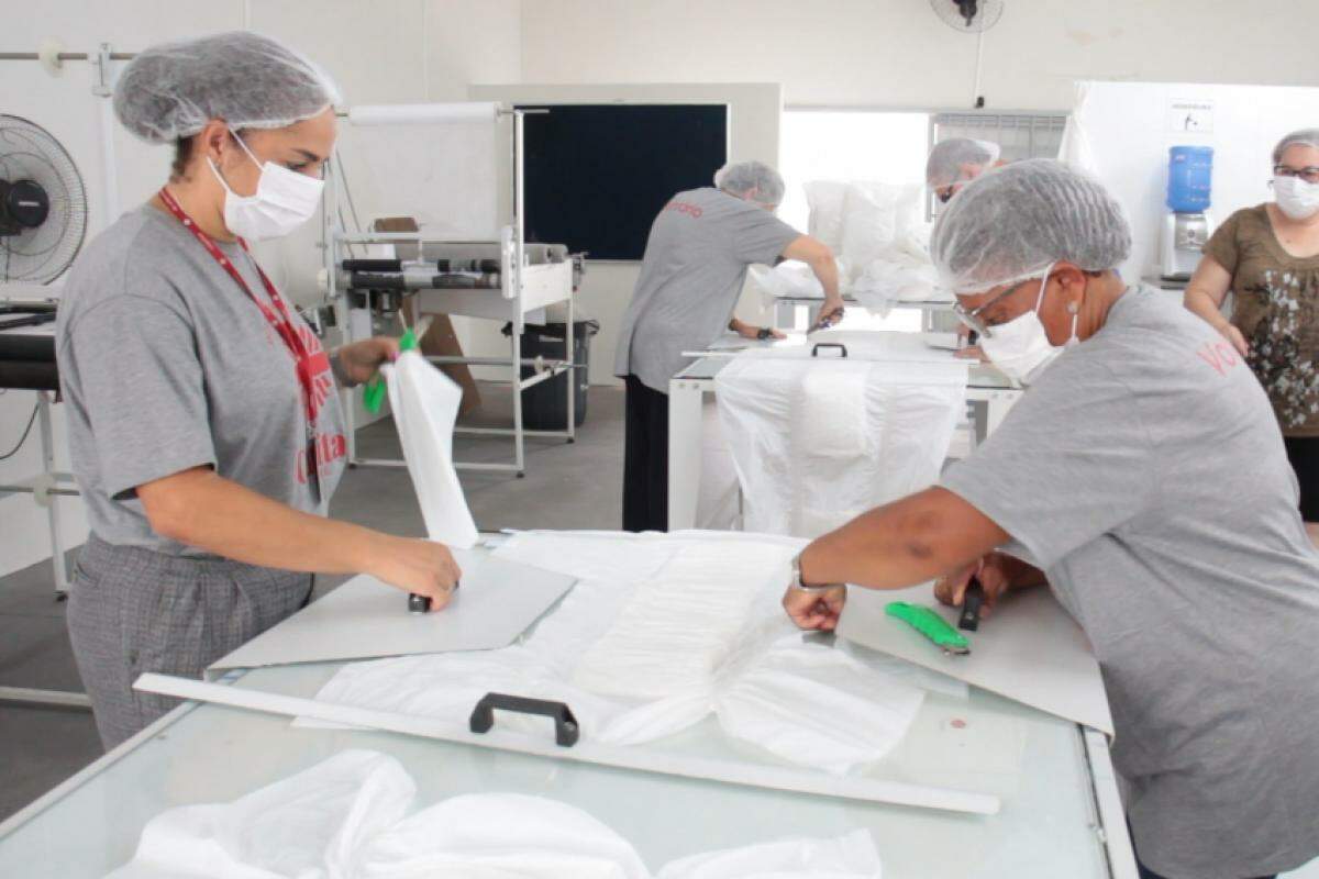 Voluntárias trabalham na confecção das fraldas, na Cáritas 